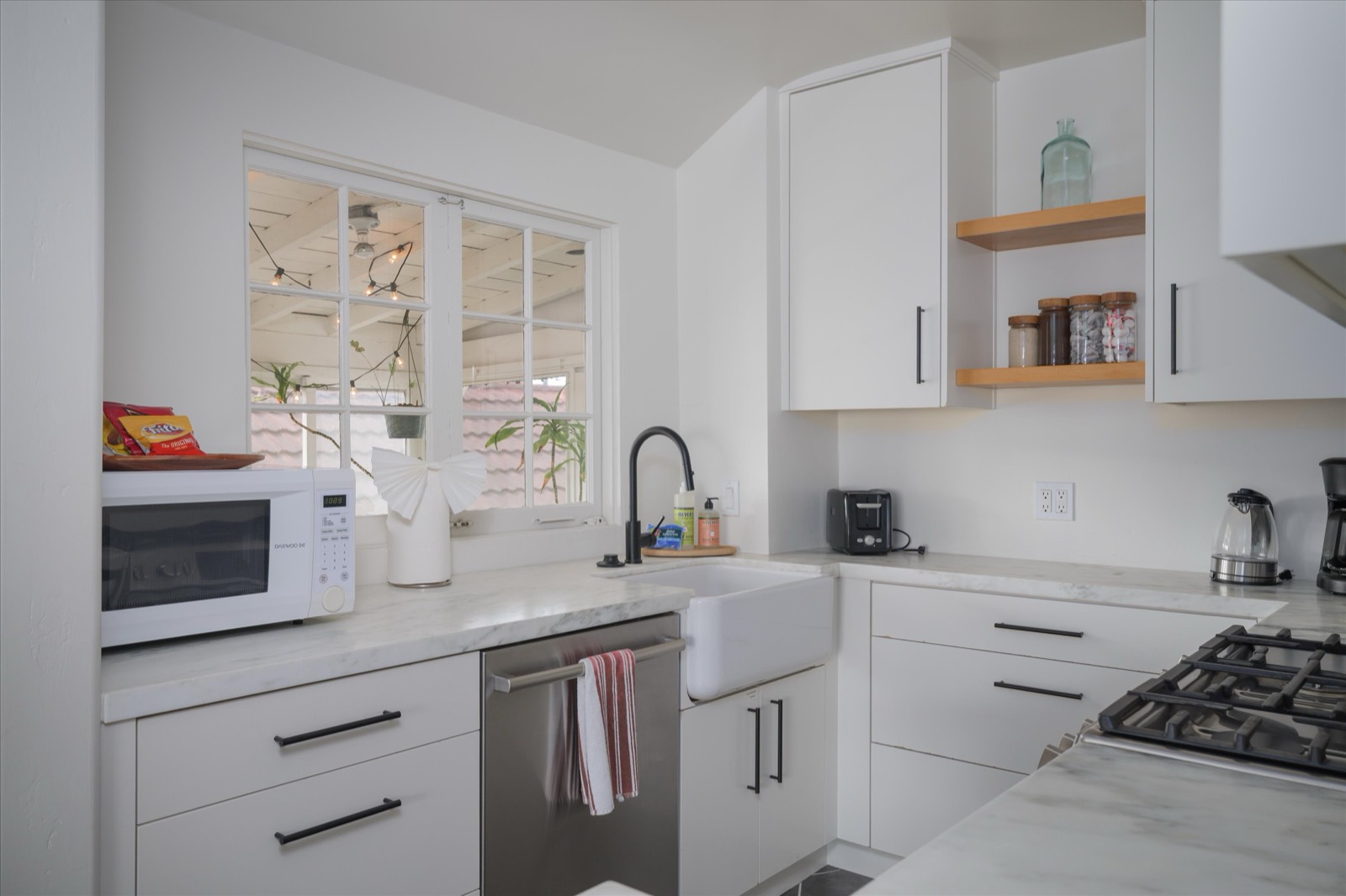 Kitchen with marble counters and farmhouse sink